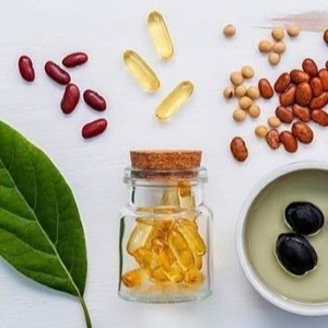 Omega-3 supplements with a selection of legumes and oils