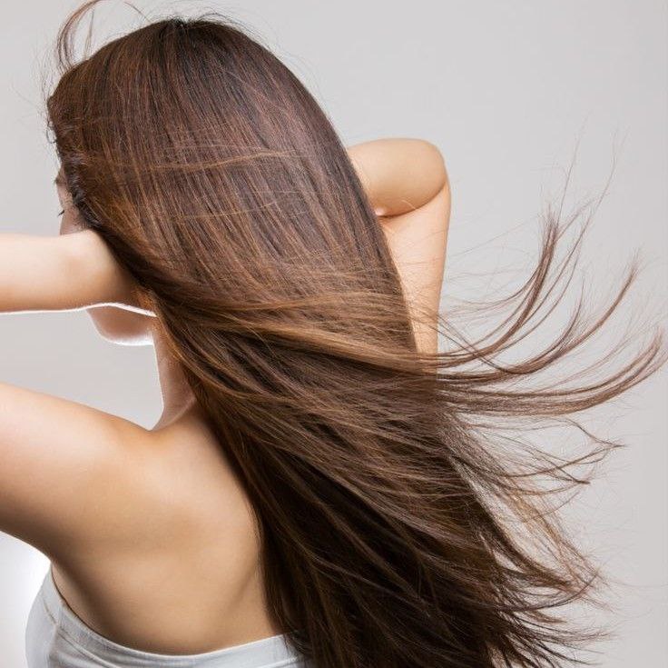 A girl with long, healthy, and shiny hair — the result of proper care.