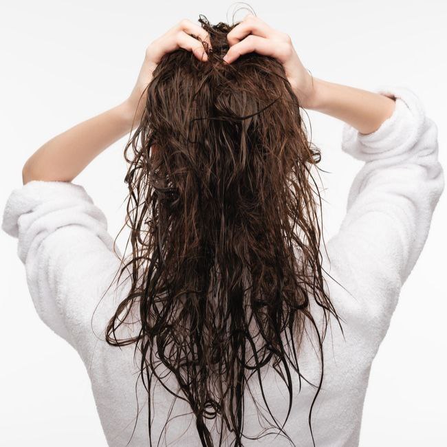 Incorrect and aggressive rubbing of hair with a towel, leading to damage.