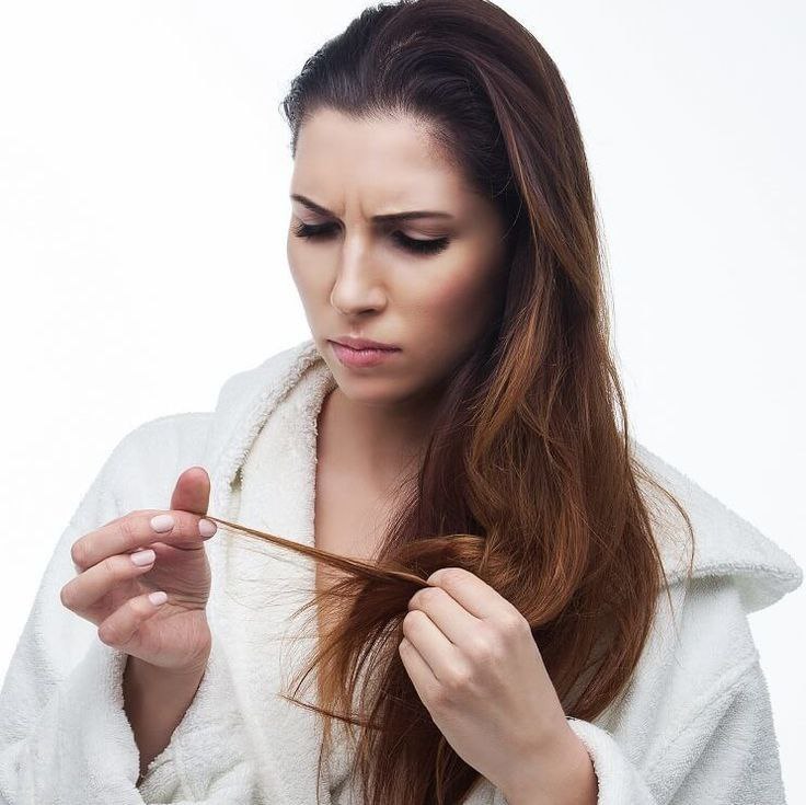 A woman with beautiful wavy hair styled into a hairdo.